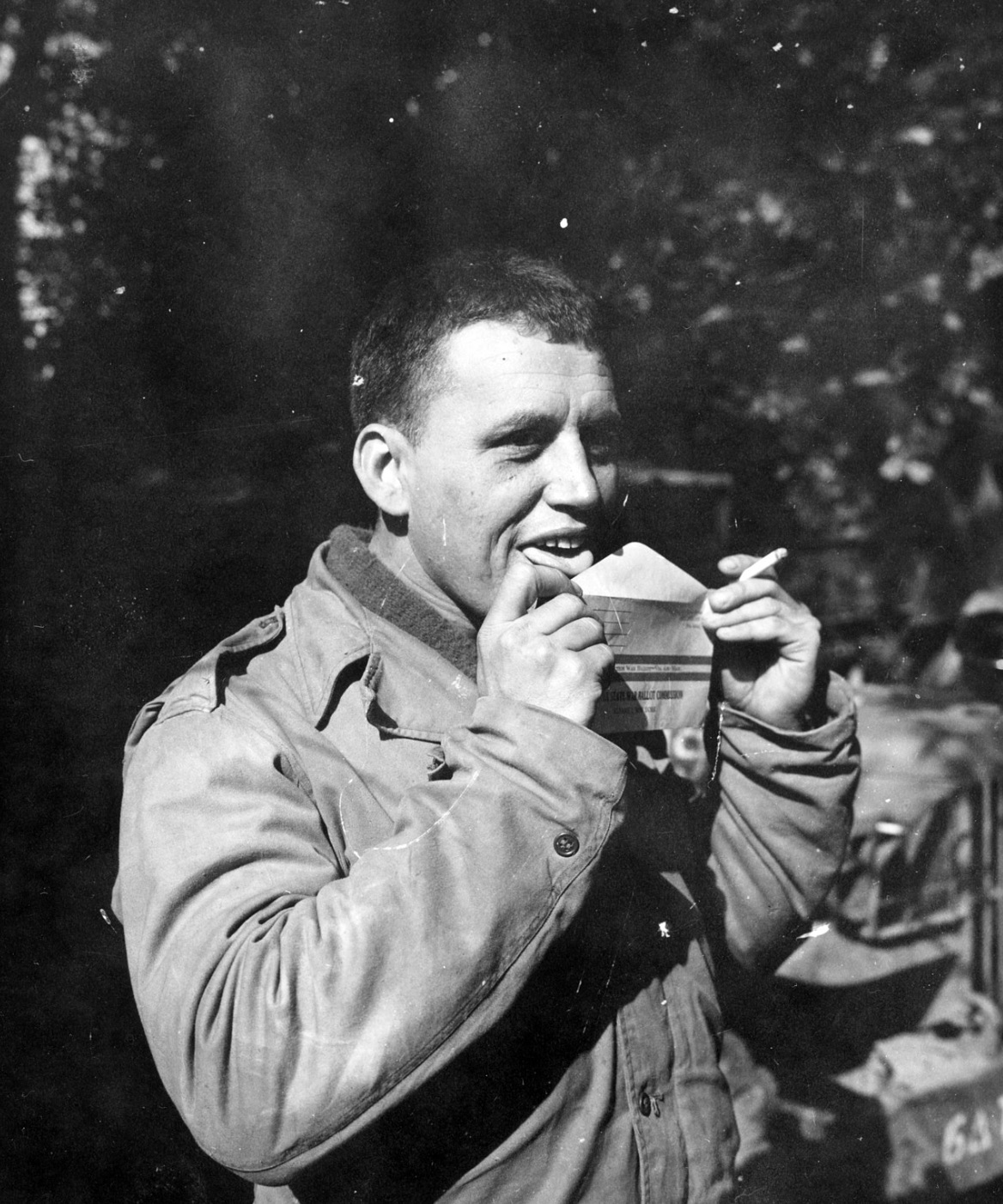 A soldier sealing his voting ballot 